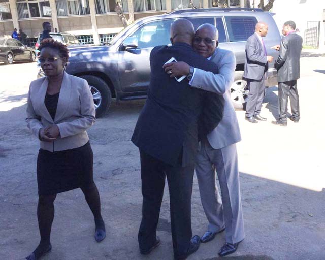 Minister Mushowe and Bishop Manhanga greet each other as they arrive for the launch 