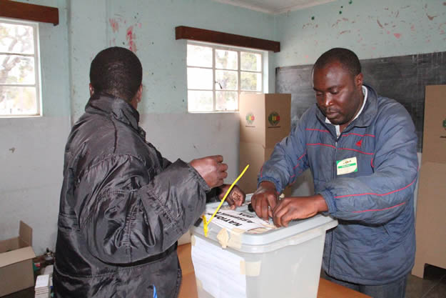 Polling officers sealing ballot boxes before voting starts in Domboshava