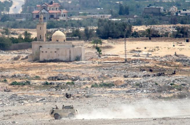 Egyptian security forces travel in an armored personnel carrier near Egypt's border with Israel. (AFP/File)