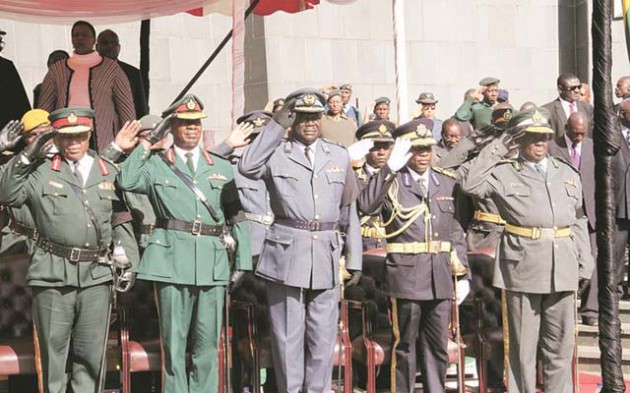 Service Chiefs salute during Dr Charles Utete’s burial