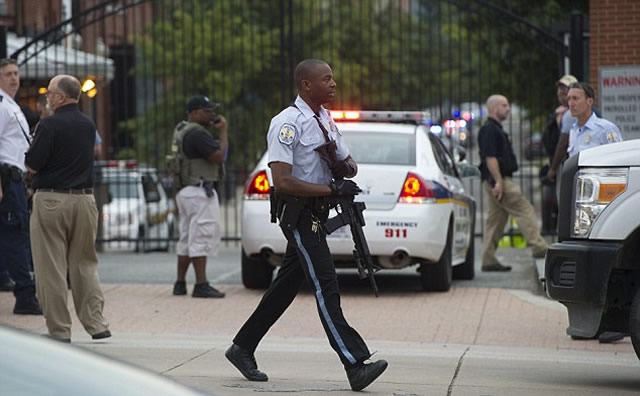 Armed: Police respond to the report of a shooting at the Navy Yard in Washington, DC, September 16, 2013. A gunman shot and wounded at least one person Monday in a headquarters building at the US Navy Yard in Washington. – AFP/Getty Images.