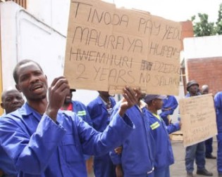 Trinidad Engineering workers protest in front of their offices in Msasa, Harare, yesterday having gone for two years without pay