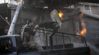 A file photo showing a member of the foreign-backed militants fires at Syrian government forces in Aleppo. – Press TV.