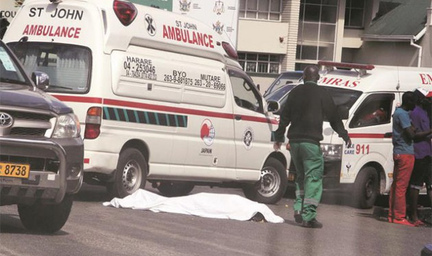 A tout was crushed to death after disembarking from a moving bus along Sam Nujoma Street in Harare yesterday. —(Picture by Tawanda Mudimu)