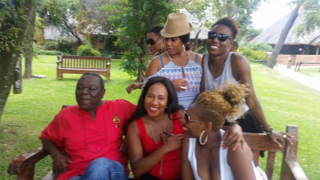 Morgan Tsvangirai poses for a picture with the unknown women.