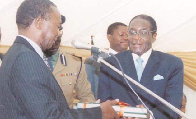 In this file picture, Chairman of the Presidential Land Review Committee Dr Charles Utete presents his committee’s report to President Mugabe at State House on September 12, 2003