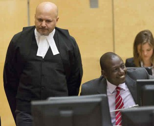 Kenya's Deputy President William Ruto (R) reacts as he sits in the courtroom before the trial at the International Criminal Court (ICC) in The Hague in September 10, 2013. Ruto appeared at the International Criminal Court on Tuesday for the opening of his trial on charges of co-orchestrating a post-election bloodbath five years ago. Ruto and his co-accused, the broadcaster Joshua arap Sang, could face long prison terms if convicted. To the left is defence counsel Karim Khan. – AFP.