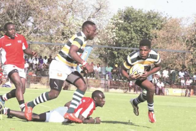 HANDS OFF . . . Zimbabwe’s Brian Matoramusha (right) evades the tackles of Kenyan players during yesterday’s game St George’s College. — (Picture by Tawanda Bote)