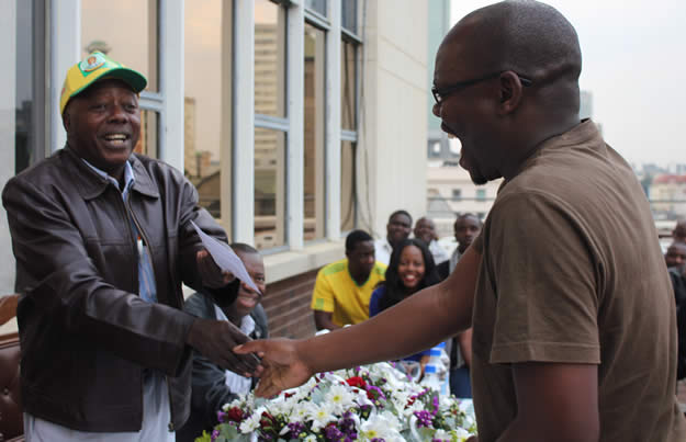 Mr Mutasa handing our senior reporter Michael Chedeme his award