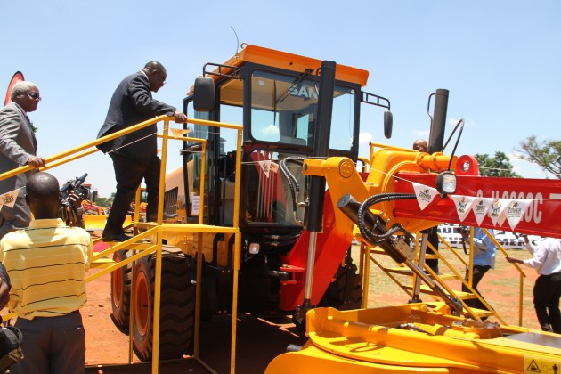 Transport and Infrastructure Development Minister Obert Mpofu leads Local Government, Public Works and National Housing Minister Ignatius Chombo into one of the graders today