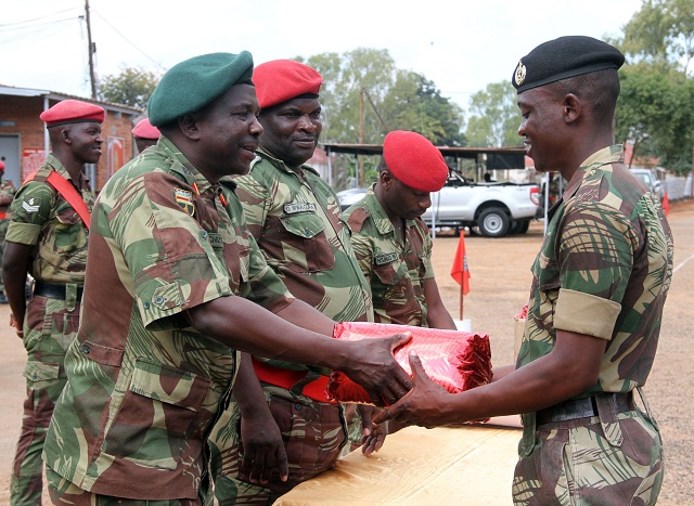 The Zimbabwe National Army Director Ordinance, Colonel Shackman Chizengwe, presents best student prize to Sergeant Gift Chirambadare during a graduation at 1 Brigade in Bulawayo on Wednesday