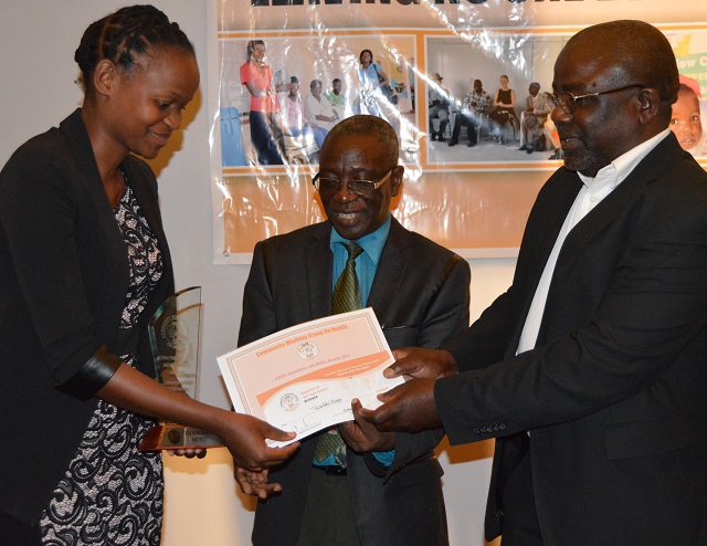 Chronicle reporter Thandeka Moyo (left) receives a certificate and a trophy from Mr Douglas Moyo, the Bulawayo National Aids Council officer (right), while Mr Nobert Dube of the Community Working Group on Health (CWGH) looks on during the CWGH Health reporting journalists awards at a Bulawayo hotel on Friday. Thandeka won the best CWGH health reporter award