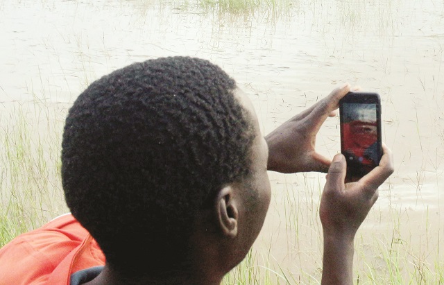 Some villagers and farmers’ crops in Umguza District, Matabeleland North Province, were seriously affected by Cyclone Dineo-induced floods as their maize crop which was at tasseling stage was submerged in water. The picture taken last year at Mtambo Village shows a passerby taking a picture of the submerged crop. — Picture by Eliah Saushoma