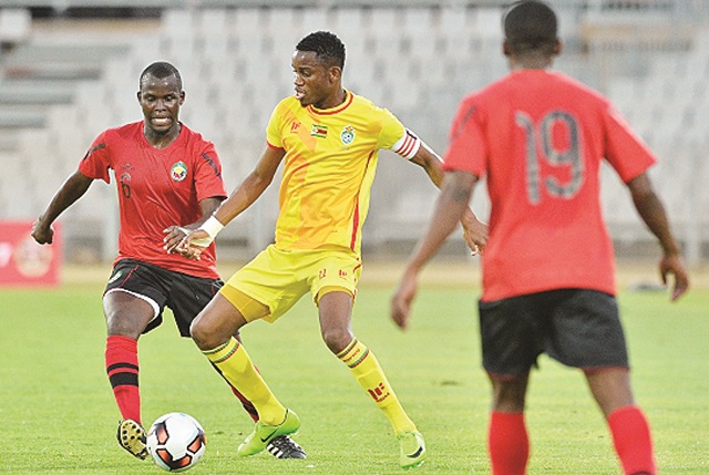 Zimbabwe’s Ovidy Karuru is challenged by Abilio Moucuona of Mozambique during the Cosafa Castle Cup match between Mozambique and Zimbabwe at the Moruleng Stadium in Rustenburg yesterday. — BackpagePix