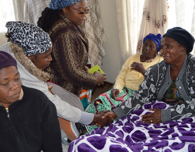 The late former Deputy president of the Senate Cde Naison Khutshwekhaya Ndlovu’s widow Sithokozile (right) is consoled by neighbours and friends at her house in Luveve suburb yesterday after the passing on of her husband. — Pic by Dennis Mudzamiri