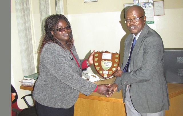 Mrs Josephine Mhlanga hands over the ZNCC Constructor of the Year 2016 award to the Nemaks Construction and Engineering Services Managing Director, Engineer Newton Mlotshwa