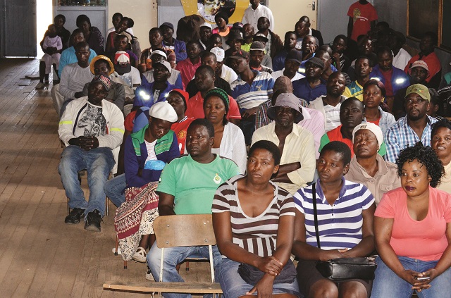 Zanu- PF members follow proceedings at a meeting held at Davies Hall in Bulawayo yesterday