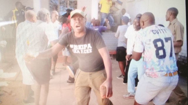A brick-wielding youth at Zanu-PF’s Davies Hall in Bulawayo on Sunday