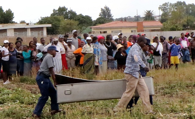 Police carry the woman’s body