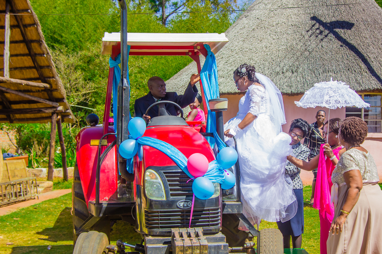 WEDDINGS: Wheelbarrows and tractors at a wedding