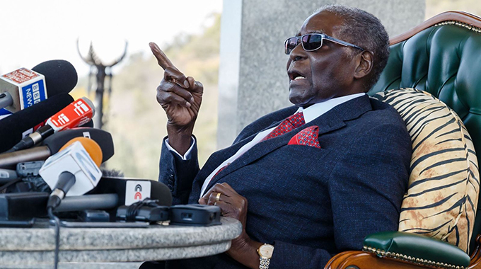 Like a hermit, frail looking Mugabe emerges