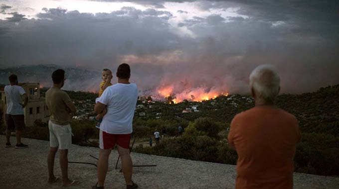 Flames ravage Greek seaside as wildfires kill 74