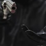 One suspect pointed a firearm, while others dragged the victims into nearby grass