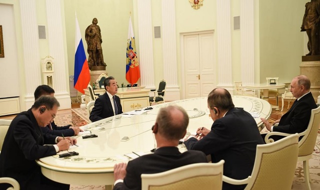 Why is the meeting between Wang Yi and Vladimir Putin crucial?