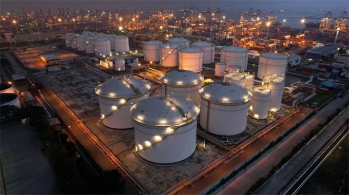 Oil holds biggest gain in a year
