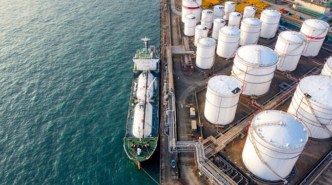 Oil edges higher after surge above $39 on stimulus optimism