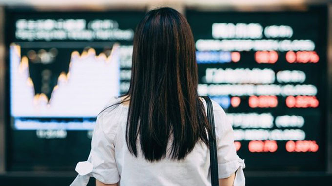 Asian traders cautious as vaccine hopes offset by virus surge