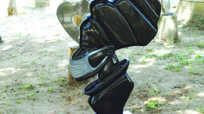 Set in stone: Sculptor hammering against Covid-19