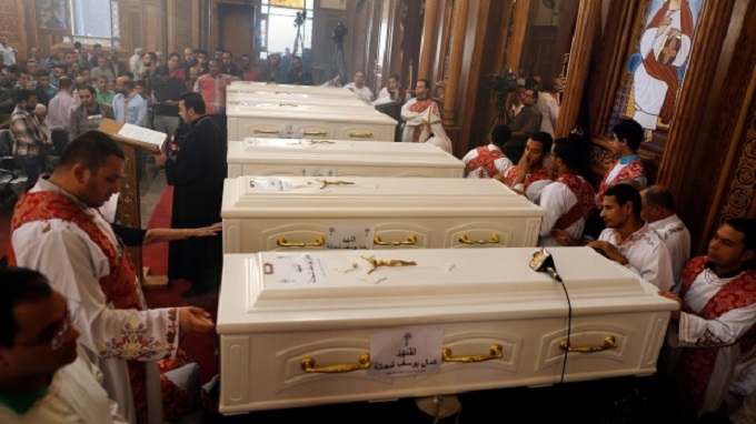Christians in Egypt bury their dead after attack
