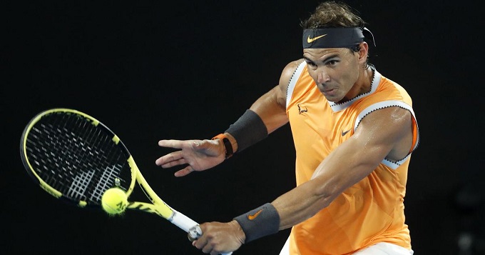 Nadal battles from set down to reach last 16