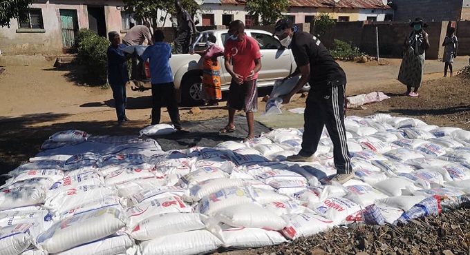 Esrom Nyandoro donates mealie meal to 300 residents