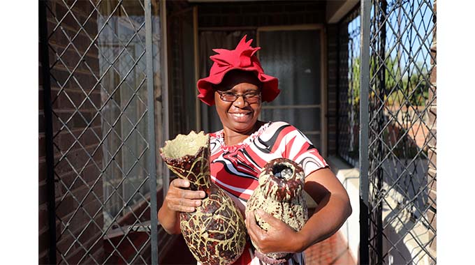 Teacher makes vases from isitshwala, waste paper